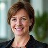 Portrait of Sarah M., 42, Marketing Director, smiling confidently.